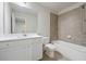 Bathroom featuring a bathtub with tile surround, and a white vanity with countertop and sink at 791 Belrose Dr, Smyrna, GA 30080