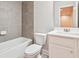 Bathroom with a white vanity and sink, and a toilet next to a bathtub with gray tile surround at 791 Belrose Dr, Smyrna, GA 30080
