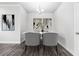 Elegant dining area showcasing stylish decor, a modern chandelier, and wood flooring at 791 Belrose Dr, Smyrna, GA 30080