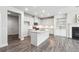 Modern kitchen featuring white cabinets, granite countertops, stainless steel appliances, and a fireplace at 791 Belrose Dr, Smyrna, GA 30080