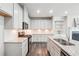 Stylish kitchen with white cabinets, granite countertops, herringbone backsplash, and stainless steel appliances at 791 Belrose Dr, Smyrna, GA 30080