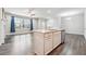 Open-concept living room and kitchen featuring an island with a sink and stainless steel appliances at 791 Belrose Dr, Smyrna, GA 30080