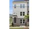 Charming three-story townhome features brick accents, large windows, and a welcoming entrance with a small awning at 2569 Astaire Ct, Atlanta, GA 30318