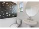 Simple and clean powder room with pedestal sink, modern art, and natural light at 2569 Astaire Ct, Atlanta, GA 30318