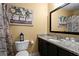 Functional bathroom with dark cabinetry, granite counters, and decorative art for a touch of personality at 392 Fourth St, Forest Park, GA 30297