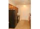 Kitchen featuring dark appliances, light wood cabinets, and tile flooring at 4750 Crinklepoint Ct, Douglasville, GA 30134