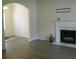 Cozy living room featuring a classic fireplace with marble accents and modern gray flooring at 4750 Crinklepoint Ct, Douglasville, GA 30134