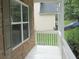 Inviting porch with stone accents, white railings, and a view of the lush green lawn at 4750 Crinklepoint Ct, Douglasville, GA 30134