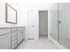 Bright bathroom featuring gray vanity cabinets, a glass shower and neutral tile flooring at 1005 Crown Oak St # 44, Johns Creek, GA 30022