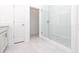 Bright bathroom featuring gray vanity cabinets, a glass shower and neutral tile flooring at 1005 Crown Oak St # 44, Johns Creek, GA 30022