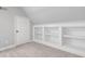 Attic space with dormer, white built in shelving and carpeting at 2525 Millwater Xing, Dacula, GA 30019