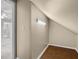 Storage space in an attic with hardwood floors and a window looking into a room at 2525 Millwater Xing, Dacula, GA 30019