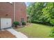 Expansive backyard features a well-manicured lawn and access to upper-level deck at 2525 Millwater Xing, Dacula, GA 30019