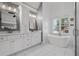 Bright bathroom featuring double vanity, soaking tub and modern finishes at 2525 Millwater Xing, Dacula, GA 30019