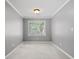 Bedroom features carpet floors, neutral walls, and natural light from a window at 2525 Millwater Xing, Dacula, GA 30019