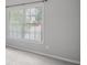 A serene bedroom showcasing a large window with blinds, light-colored walls, and plush carpeting at 2525 Millwater Xing, Dacula, GA 30019