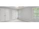 Bedroom with neutral colored walls, carpet floors, and a window providing natural light at 2525 Millwater Xing, Dacula, GA 30019