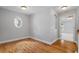 A bedroom with hardwood floors and a view to a room with neutral carpet at 2525 Millwater Xing, Dacula, GA 30019