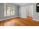 Sunny bedroom featuring hardwood floors and neutral paint, offering a serene space at 2525 Millwater Xing, Dacula, GA 30019
