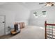 Upstairs bonus room with skylights, carpet flooring, neutral walls and a wood cabinet at 2525 Millwater Xing, Dacula, GA 30019