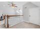 Upstairs bonus room with skylights, carpet flooring, neutral walls and a wood railing at 2525 Millwater Xing, Dacula, GA 30019