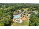 Aerial view showcasing a community pool, playground, and clubhouse surrounded by lush greenery and well-manicured lawns at 2525 Millwater Xing, Dacula, GA 30019