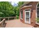 Wood deck provides access to the home's screened door, offering a seamless indoor-outdoor transition at 2525 Millwater Xing, Dacula, GA 30019