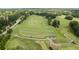An aerial view of a large driving range with multiple teeing areas, manicured fairways, and surrounding green spaces at 2525 Millwater Xing, Dacula, GA 30019