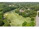 Overhead view of a pristine golf course featuring manicured greens, mature trees, and well-defined fairways at 2525 Millwater Xing, Dacula, GA 30019