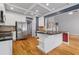 Modern kitchen boasts stainless steel appliances and an island with sleek black countertops at 2525 Millwater Xing, Dacula, GA 30019