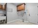 Functional laundry room with cabinets, utility sink, and tile floor at 2525 Millwater Xing, Dacula, GA 30019