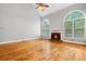 Spacious living room with a brick fireplace, hardwood floors, and vaulted ceilings at 2525 Millwater Xing, Dacula, GA 30019