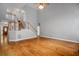 Large living room with hardwood floors, staircase, and ample natural light at 2525 Millwater Xing, Dacula, GA 30019