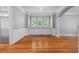A well lit Living Room showcasing beautiful trim and hardwood floors at 2525 Millwater Xing, Dacula, GA 30019