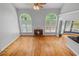 Inviting living room with fireplace, hardwood floors, large windows, a ceiling fan, and neutral walls at 2525 Millwater Xing, Dacula, GA 30019