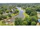 Aerial view featuring a serene pond surrounded by lush greenery, residential homes, and recreational facilities at 2525 Millwater Xing, Dacula, GA 30019