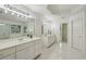 Bright bathroom showcasing double sinks, lots of cabinet space, an expansive mirror, and modern fixtures at 340 Old York Rd, Johns Creek, GA 30097