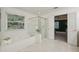 Serene bathroom with a soaking tub, glass-enclosed shower, and a window offering natural light and greenery at 340 Old York Rd, Johns Creek, GA 30097