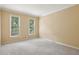 Inviting bedroom with neutral walls, two windows bringing in natural light, and plush carpeting at 340 Old York Rd, Johns Creek, GA 30097