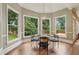 Bright breakfast nook with a table set for four and large windows offering views of the backyard at 340 Old York Rd, Johns Creek, GA 30097
