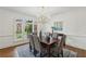 Formal dining room features elegant chandelier, large window, and refined decor at 340 Old York Rd, Johns Creek, GA 30097
