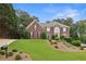 Charming two-story brick home with a manicured lawn and mature trees at 340 Old York Rd, Johns Creek, GA 30097
