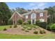 Charming two-story brick home with a landscaped yard and mature trees at 340 Old York Rd, Johns Creek, GA 30097