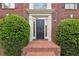 Elegant front entrance with a black door, brick steps and manicured bushes at 340 Old York Rd, Johns Creek, GA 30097