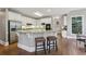 Kitchen features white cabinets, stainless steel appliances, granite countertops, and breakfast bar seating at 340 Old York Rd, Johns Creek, GA 30097