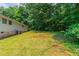 Large, grassy backyard with trees along the perimeter, perfect for outdoor activities at 6293 Silver Creek Ln, Austell, GA 30168