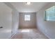 Standard bedroom featuring neutral grey walls, a small window, and a closet at 6293 Silver Creek Ln, Austell, GA 30168