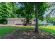 Traditional-style home with a lush front yard and a charming red porch, blending into the green surroundings at 6293 Silver Creek Ln, Austell, GA 30168
