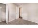 A simple bedroom features a closet and neutral-toned walls and carpets at 1026 Eisenhower Se Ct, Atlanta, GA 30354