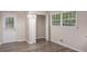 A bright dining room features hardwood floors, an entry door, and a utility closet at 1026 Eisenhower Se Ct, Atlanta, GA 30354